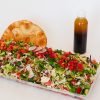 Fresh fattoush tray from Top Fruit Market Greenacre Sydney with lettuce, tomato, cucumber, radish, herbs, and toasted pita.