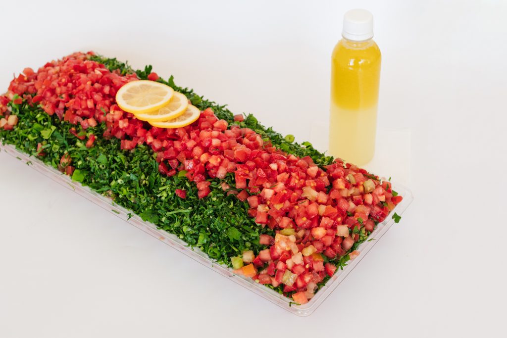 Fresh tabouli tray from Top Fruit Market Greenacre Sydney with parsley, tomato, onion, mint, and bulgur wheat.