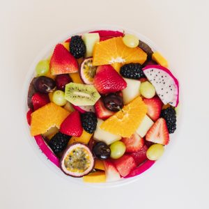 Fresh fruit salad tub from Top Fruit Market Greenacre Sydney with seasonal fruit including melon, pineapple, grapes, berries, and mango.